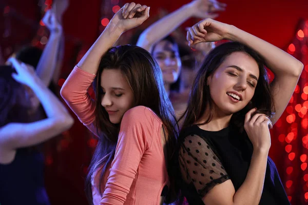 Beautiful young women dancing in night club