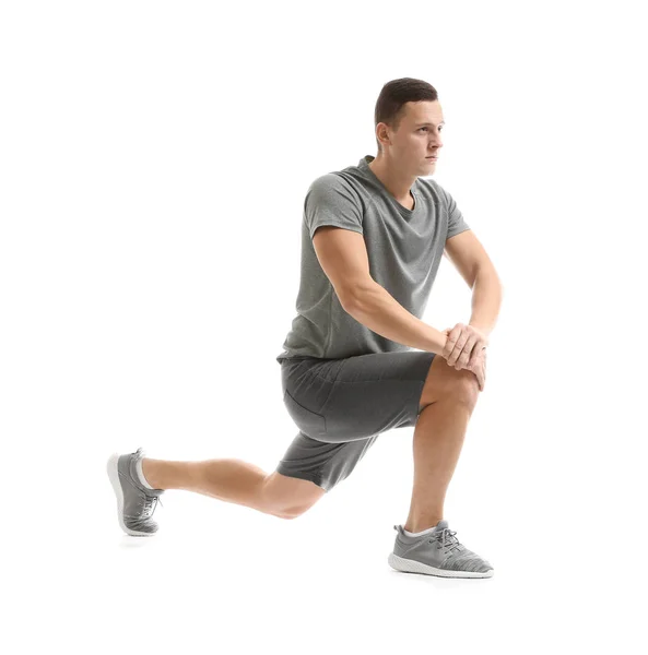 Sporty young man training against white background — Stock Photo, Image