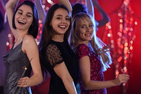 Belle giovani donne con scintille alla festa nel night club — Foto Stock