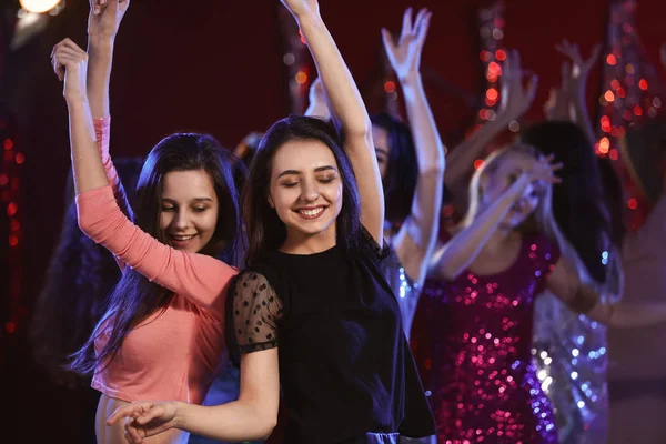 Beautiful young women dancing in night club