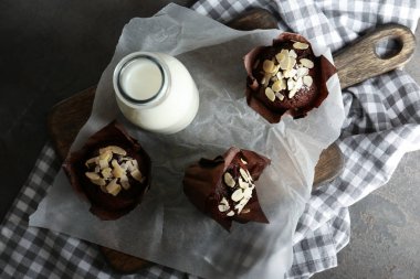 Badem lezzetli kekler ve gri tablo üzerinde süt ile kurulu