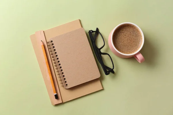 Stylish stationery with cup of coffee on color background — Stock Photo, Image