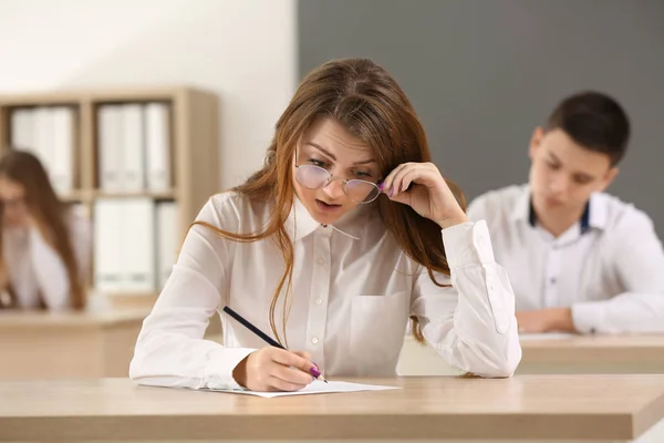 Pupils passing school test in classroom — Stock Photo, Image