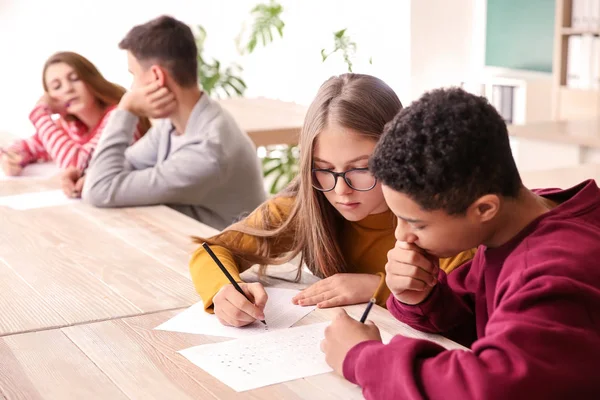 Girl cheating during school test in classroom — Stock Photo, Image