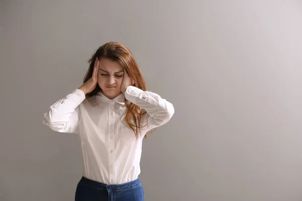 Chica estresada después de fallar la prueba de la escuela en fondo gris —  Fotos de Stock