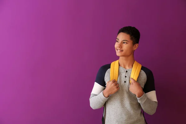 African-American schoolboy on color background — Stock Photo, Image