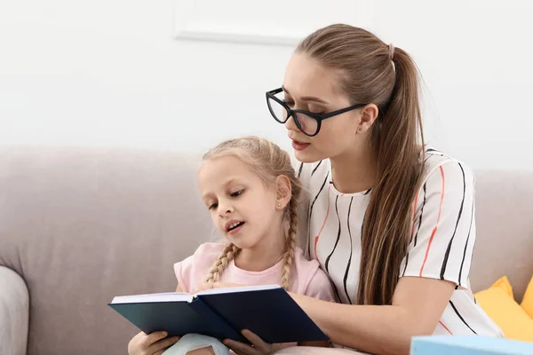 Klein meisje met Speech therapeut lezen boek in Office — Stockfoto
