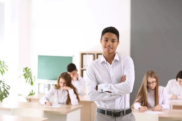 African-American boy after passing school test in classroom — Stock Photo, Image