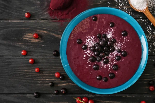 Bowl with tasty acai smoothie on wooden table — Stock Photo, Image