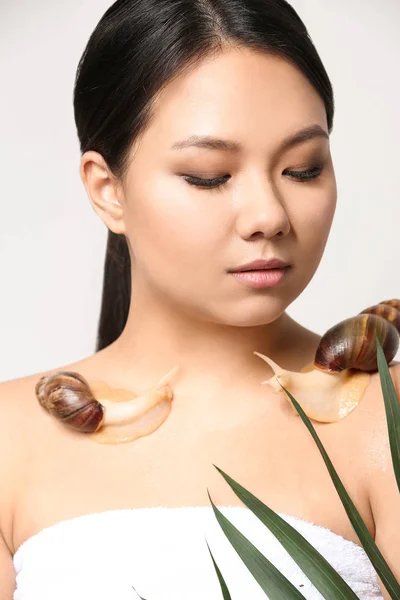 Femme asiatique avec escargots géants Achatina sur fond blanc — Photo