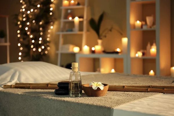 Massage stones and essential oil on table in spa salon — Stock Photo, Image