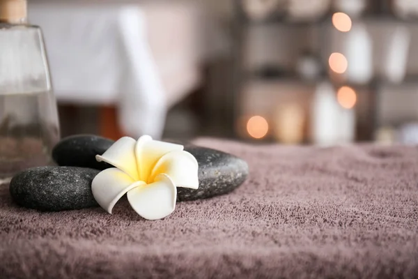 Massage stones on table in spa salon — Stock Photo, Image