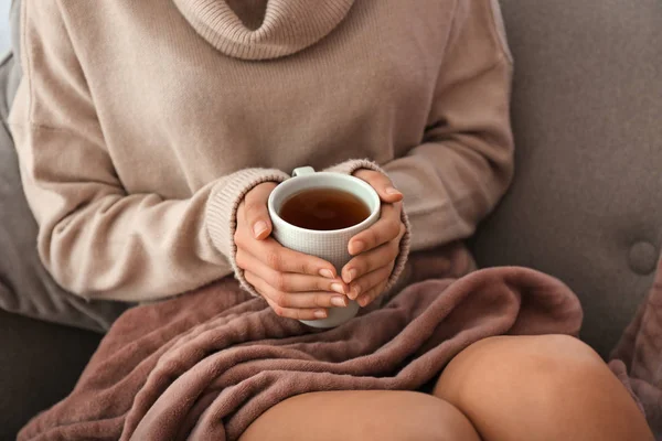 Молода жінка п'є гарячий чай вдома, крупним планом — стокове фото