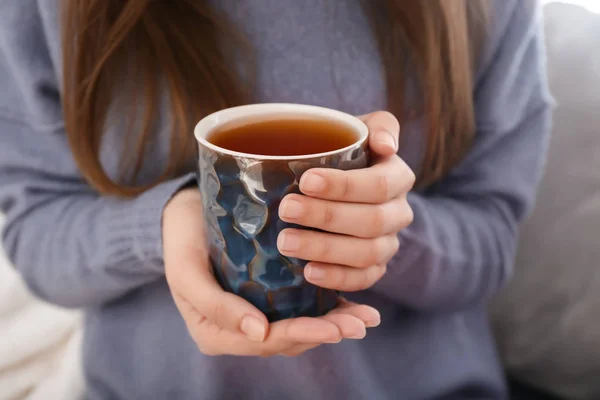 Young woman drinking hot tea at home, closeup — Stock Photo, Image