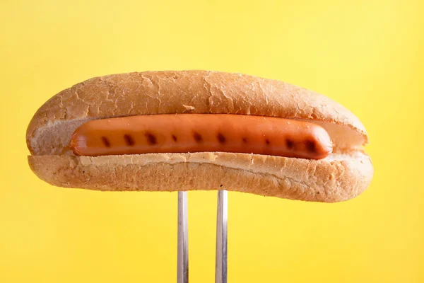 Tasty hot dog on color background — Stock Photo, Image