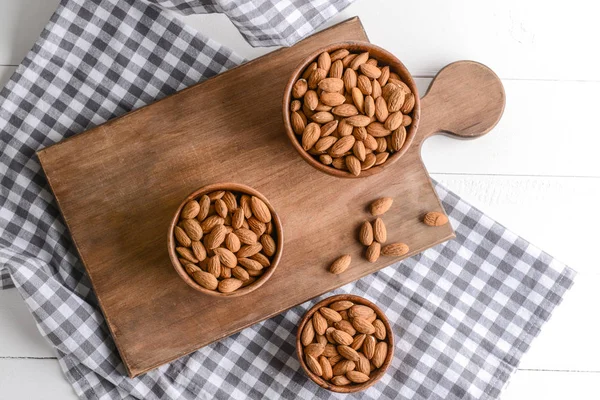 Bowls with tasty almonds on table — Stock Photo, Image