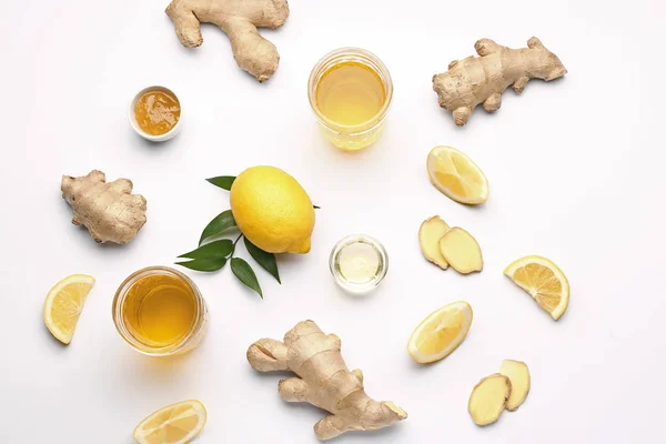 Glasses of healthy drink with ginger and lemon on white background — Stock Photo, Image