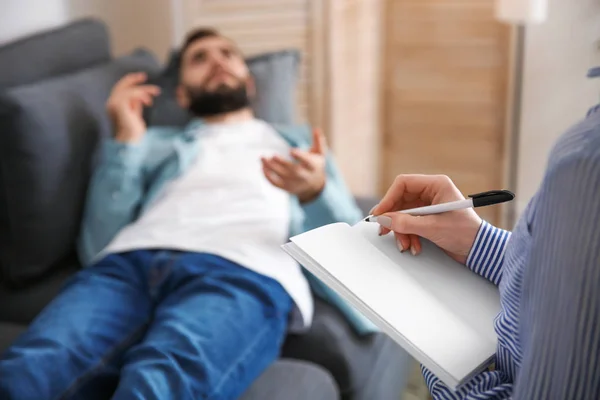 Female psychologist working with patient lying on sofa in her office — Stock Photo, Image