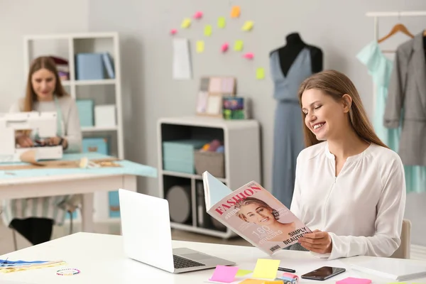Beautiful female business owner working in atelier — Stock Photo, Image