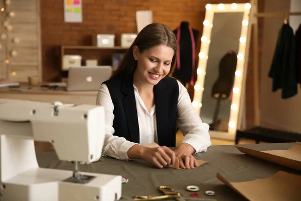 Beautiful female business owner working in atelier — Stock Photo, Image