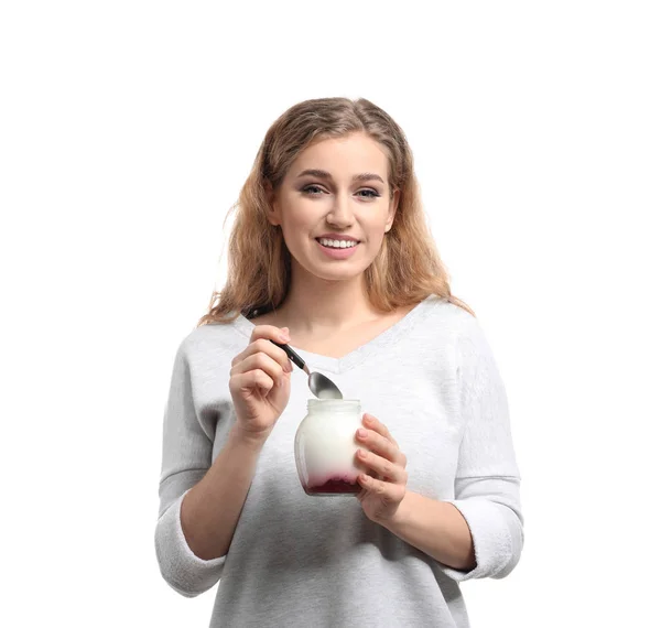 Young woman eating tasty yogurt on white background — Stock Photo, Image