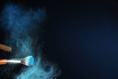 Makyaj fırça ve kaptırdın koyu arka plan üzerinde patlama