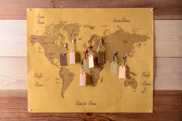 World map with tags on wooden wall — Stock Photo, Image