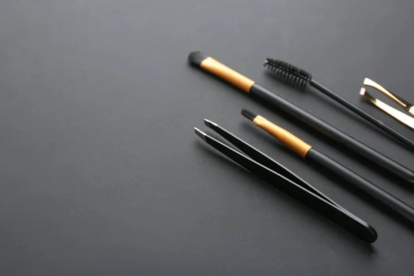 Set of tools for eyebrows correction on grey background
