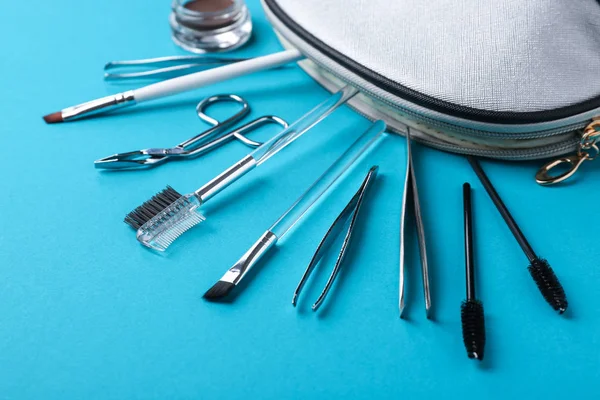 Set of tools for eyebrows correction on color background — Stock Photo, Image