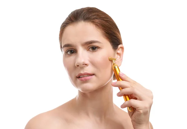 Kvinna med ansikts massage verktyg på vit bakgrund — Stockfoto