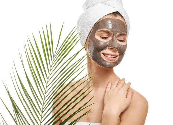 Woman with facial mask and tropical leaf on white background — Stock Photo, Image