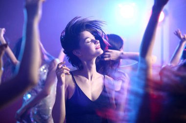 Gece kulübünde dans eden güzel genç kadınlar.
