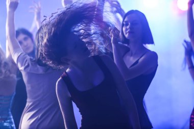 Gece kulübünde dans eden güzel genç kadınlar.