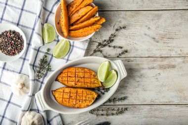 Ahşap masada lezzetli pişmiş tatlı patates ile kompozisyon