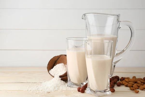 Assortment of tasty vegan milk on wooden table — Stock Photo, Image
