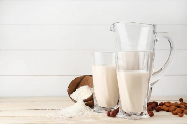 Assortment of tasty vegan milk on wooden table — Stock Photo, Image