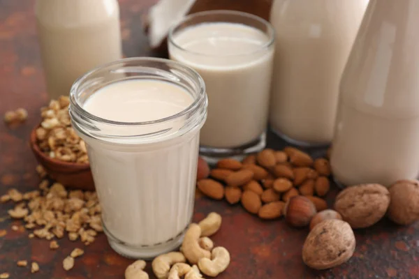 Assortment of tasty vegan milk on color background — Stock Photo, Image