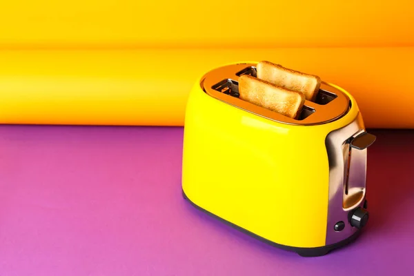 Toaster with bread slices on color background — Stock Photo, Image