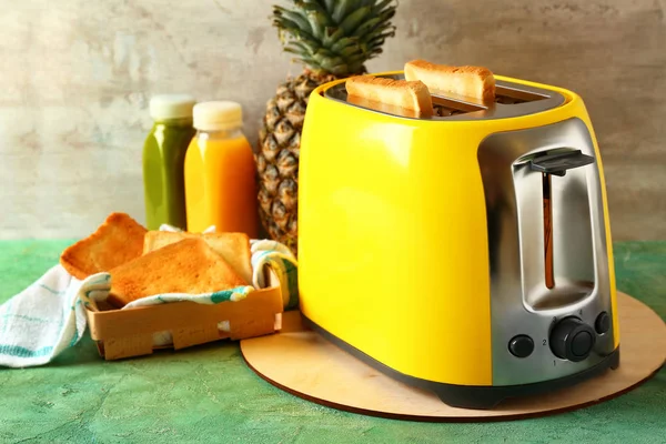 Toaster with bread slices on table — Stock Photo, Image