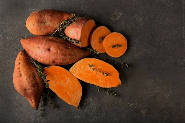 Raw sweet potato on grey table — Stock Photo, Image