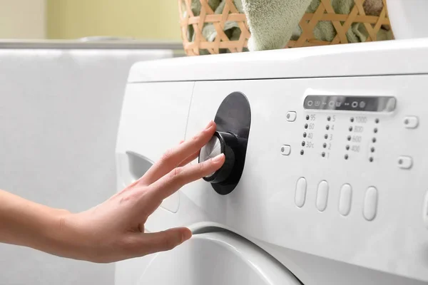 Woman switching on washing machine, closeup — Stock Photo, Image