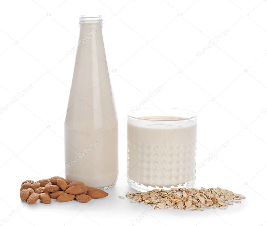 Assortment of tasty vegan milk on white background