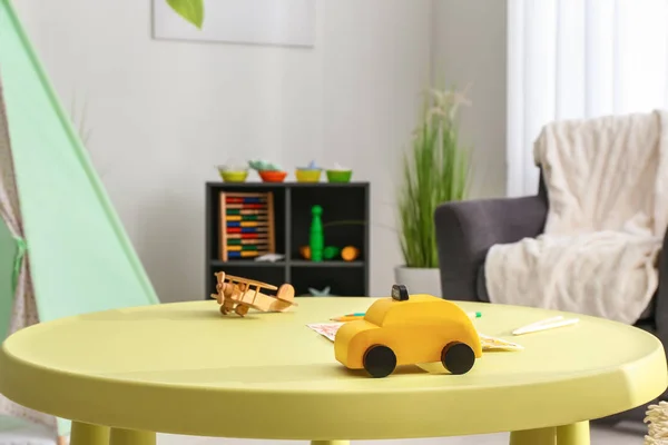 Toys on table in cozy kids room — Stock Photo, Image