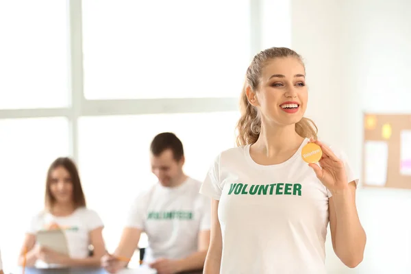 Young female volunteer at meeting — Stock Photo, Image