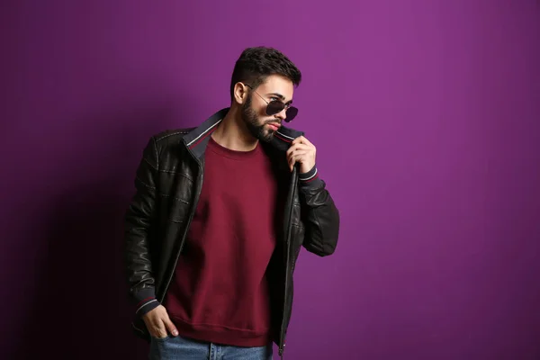 Fashionable young man on color background — Stock Photo, Image