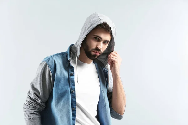 Fashionable young man on light background