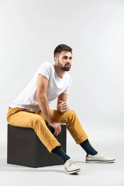 Fashionable young man on light background — Stock Photo, Image