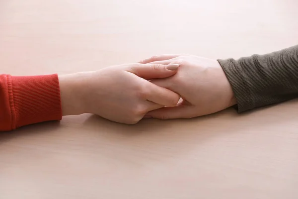 Young women holding hands on white background. Concept of support — Stock Photo, Image