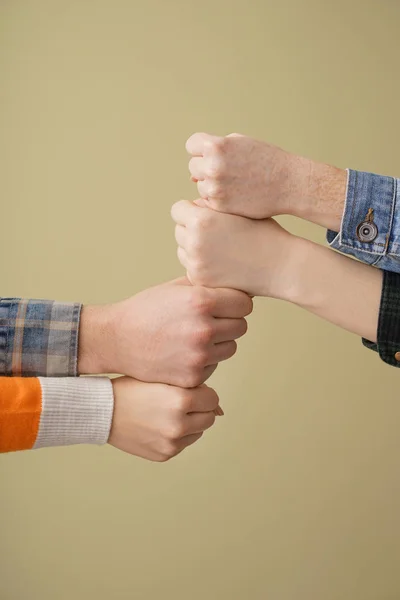 Group of people holding hands together on color background. Concept of unity