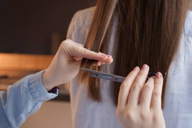 Kuaför müşteriyle güzellik salonunda çalışıyor.